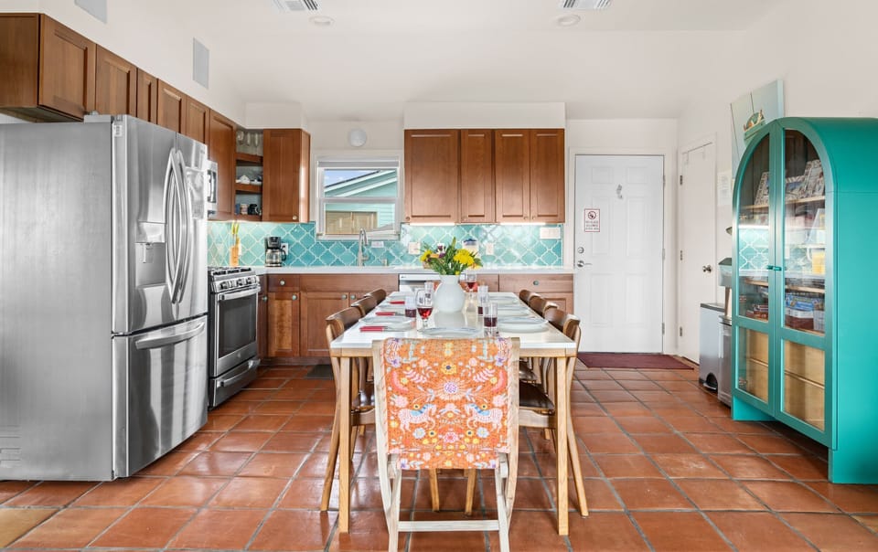 Unit 2120 — Kitchen close-up with gas range, turquoise arabesque backsplash, and quartz countertops