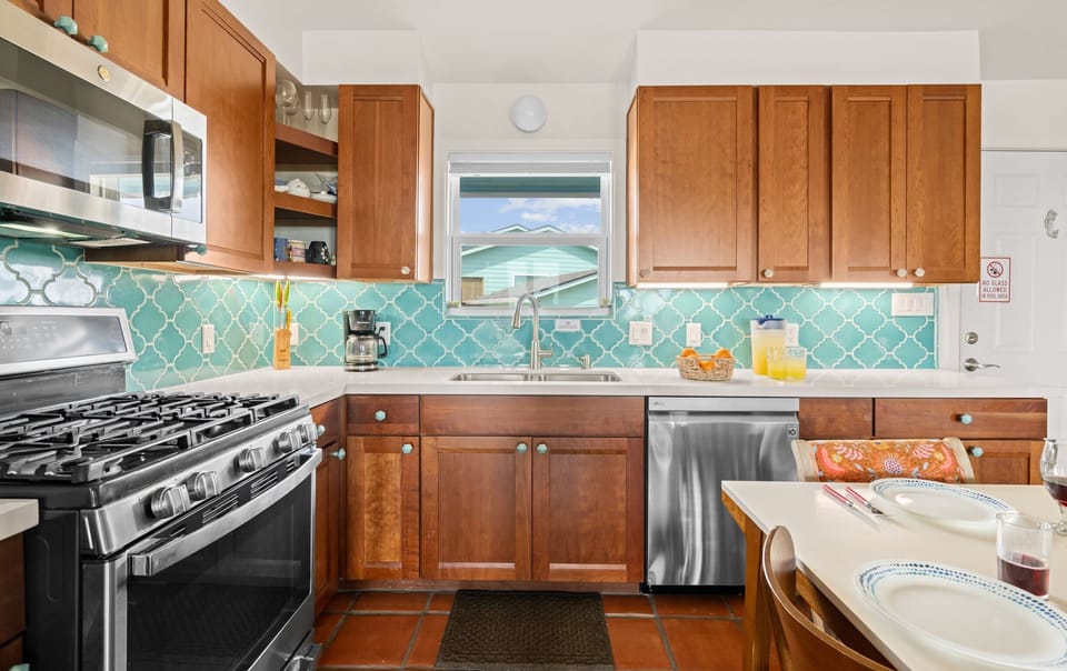 Unit 2120 — Living and dining area with reclaimed wood ceiling beams and terra cotta tile floors