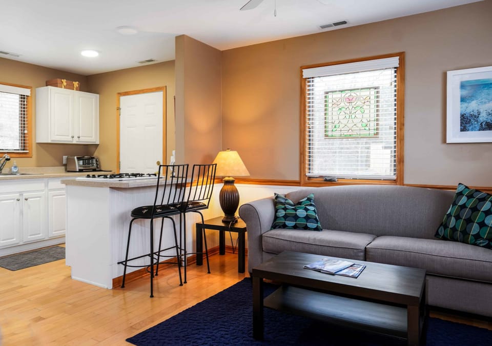 The rear guest house boasts a kitchen, living area, bathroom, and bedroom