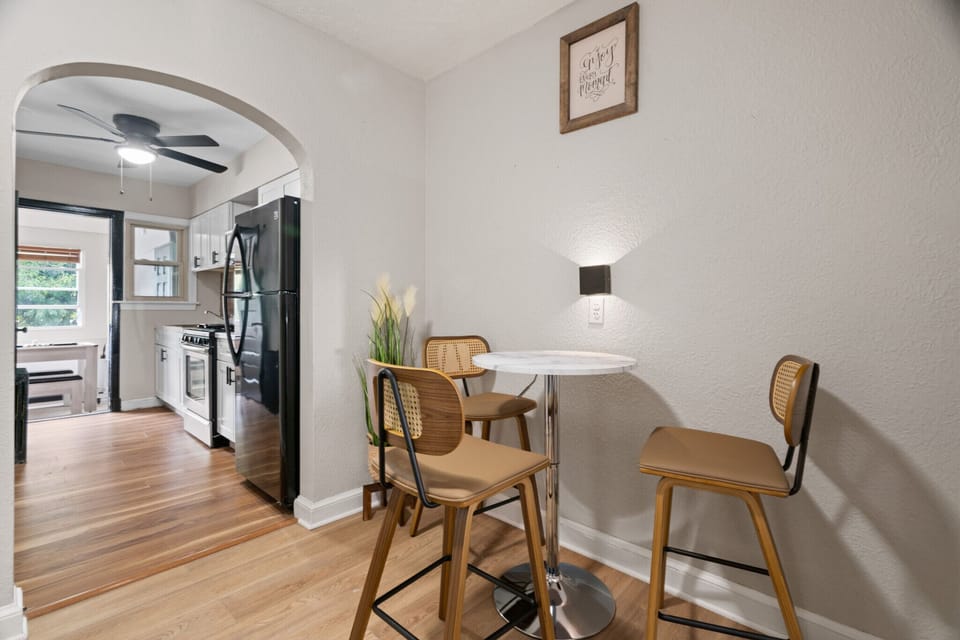 Intimate bistro-style dining nook with elegant lighting,modern high-back chairs