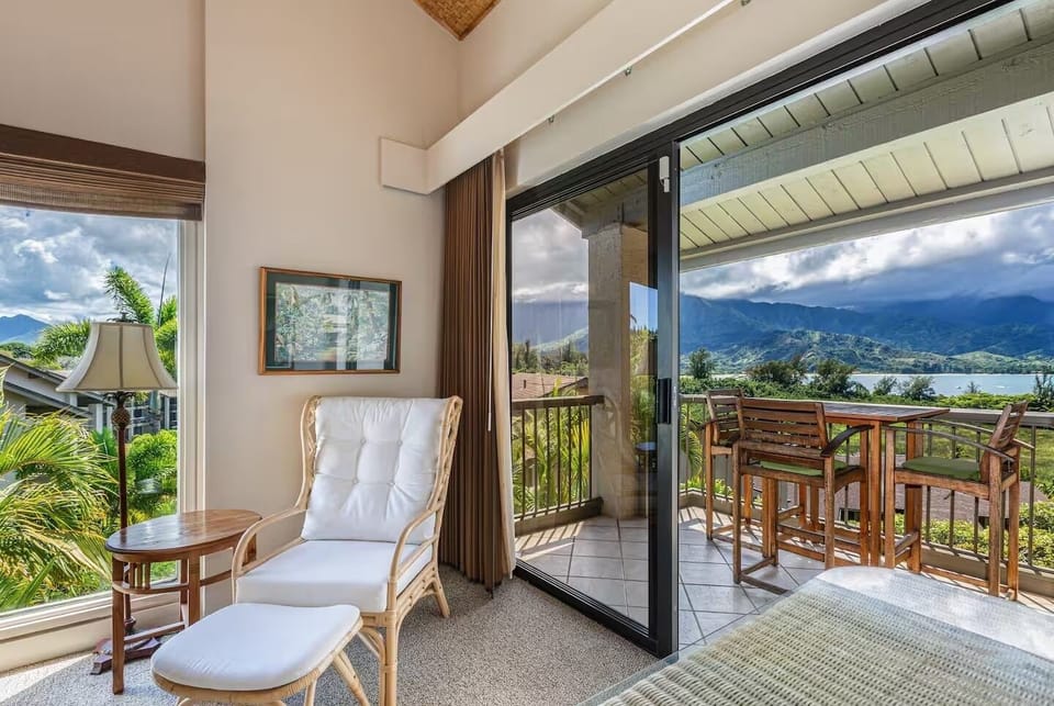 Cozy sitting area with access to the balcony and stunning mountain vistas. – Ideal for relaxing or reading with picturesque views.