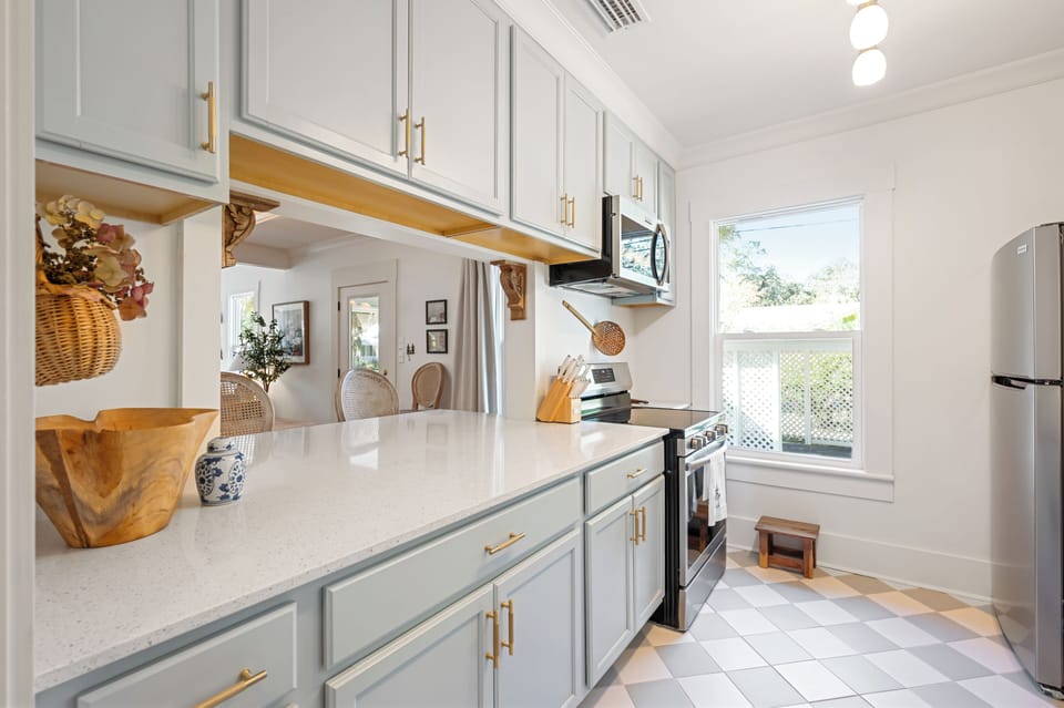 Kitchen cutout, extended bar top seating overlooking the living areas