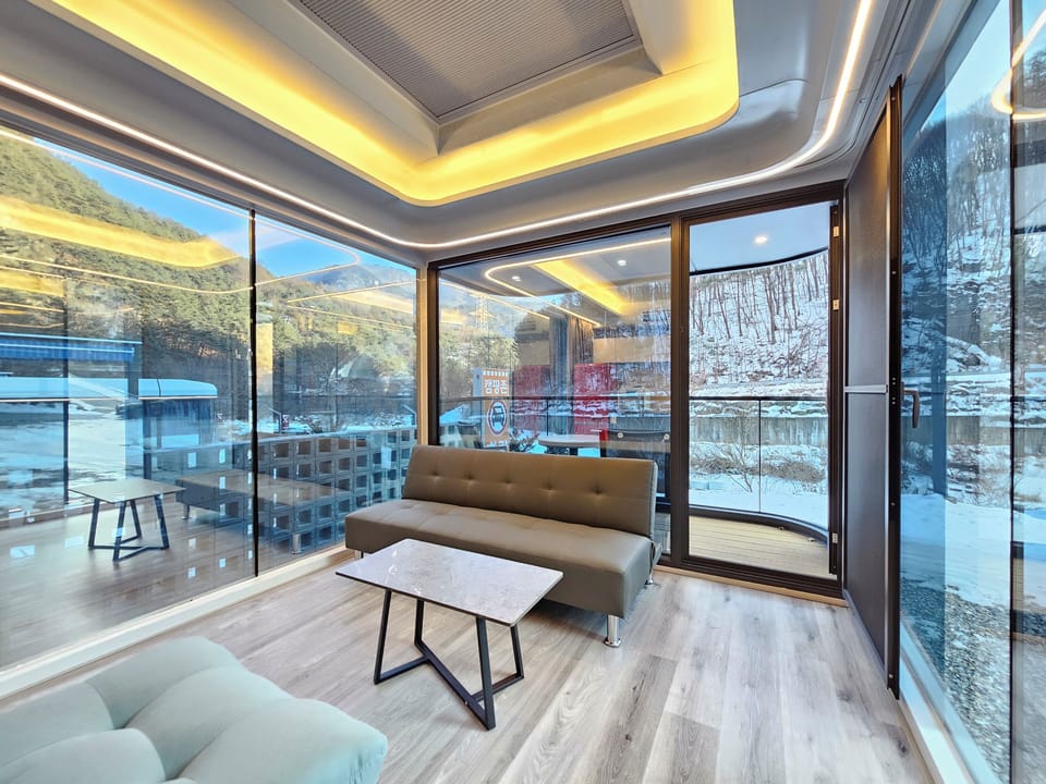 Honeymoon Double Room | Living room | 50-inch TV with cable channels, heated floors