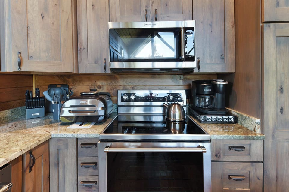 Modern kitchen with stainless steel appliances and rustic wood cabinetry