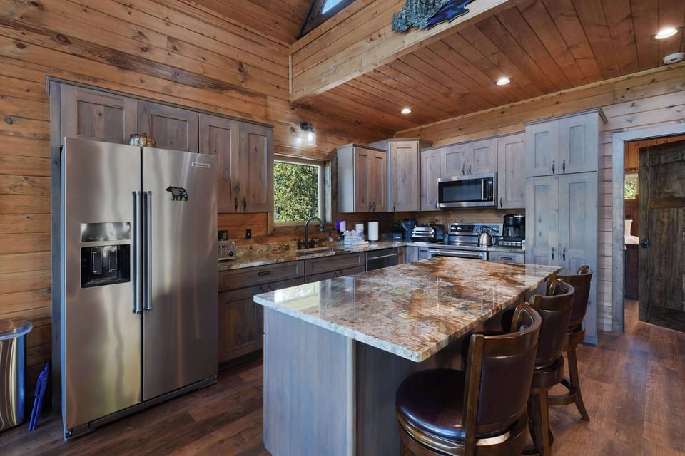 rustic kitchen with granite island and stainless steel appliances