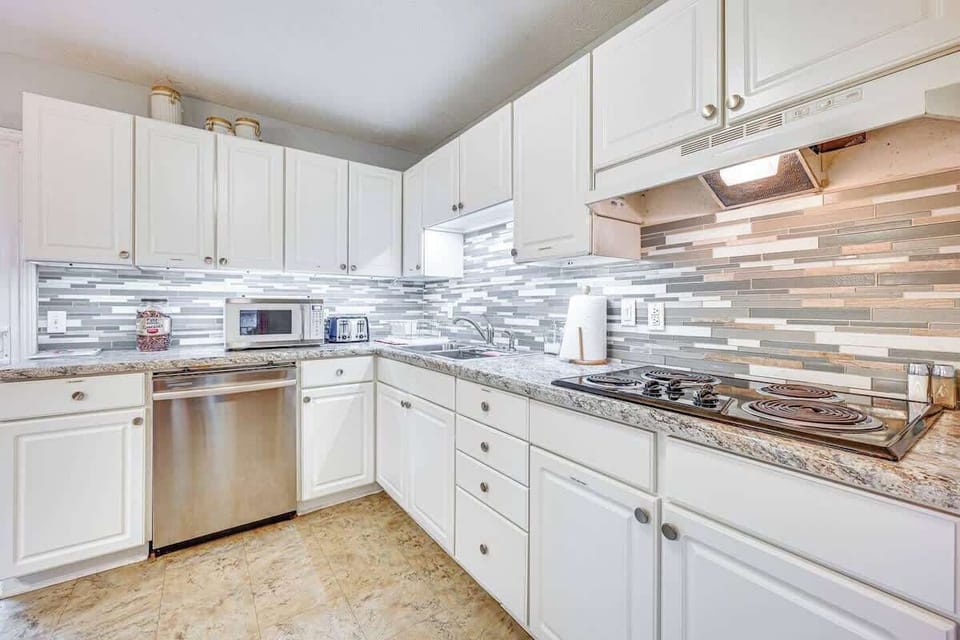 Fully equipped kitchen with bright cabinets and modern touches