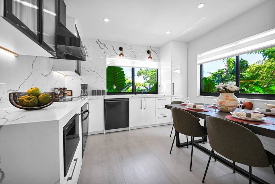 "Bright living area with bold orange chairs and modern accents."