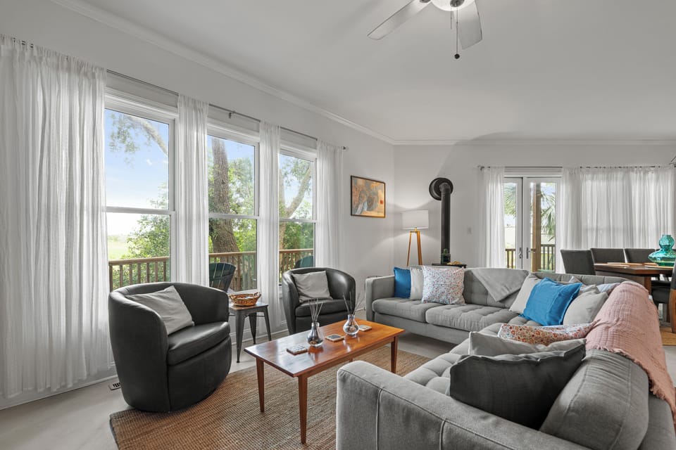 Living Room - Large sectional with two additional chairs and marsh views