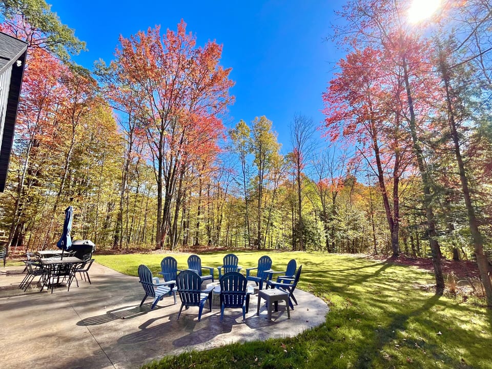 Beautiful large patio has (2) dining tables with16 chairs & Weber Propane grill.