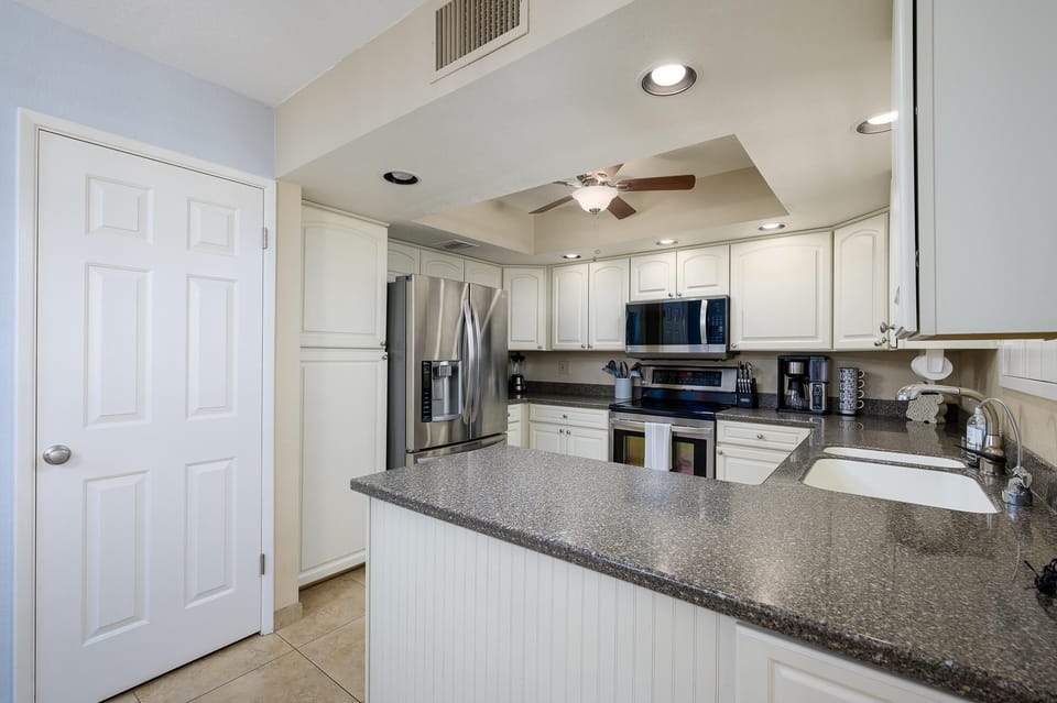 Bright kitchen with granite counter tops.