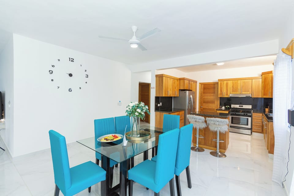 Beautiful dining room table with 6 chairs,balcony with ocean view and flowers.