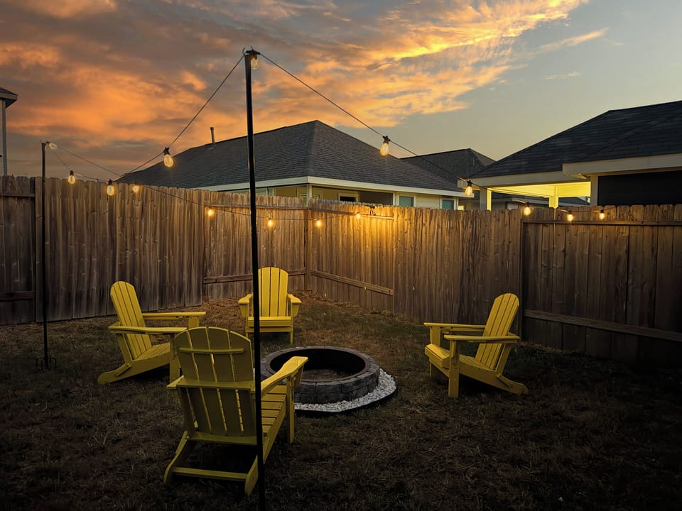 Fully fenced backyard has a nice fire pit to enjoy in the evenings