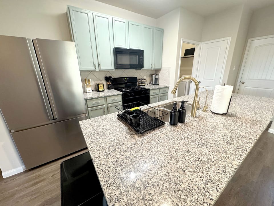 Fully stocked kitchen with reverse-osmosis water filter and a large fridge