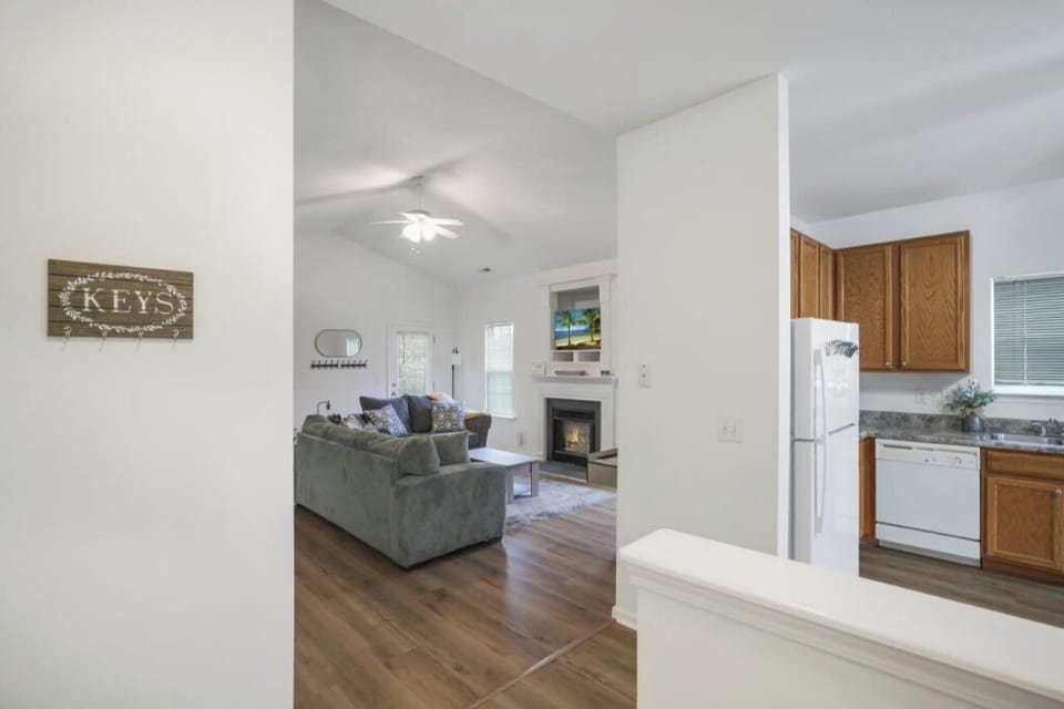 A comfy couch, fireplace, and kitchen that looks good to whip up some snacks.
