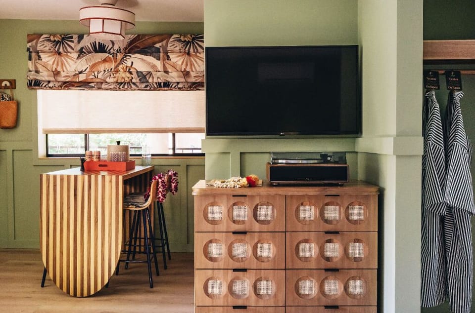 This bright and spacious room combines modernity with retro accents, offering a fun and comfortable space to relax in style.
