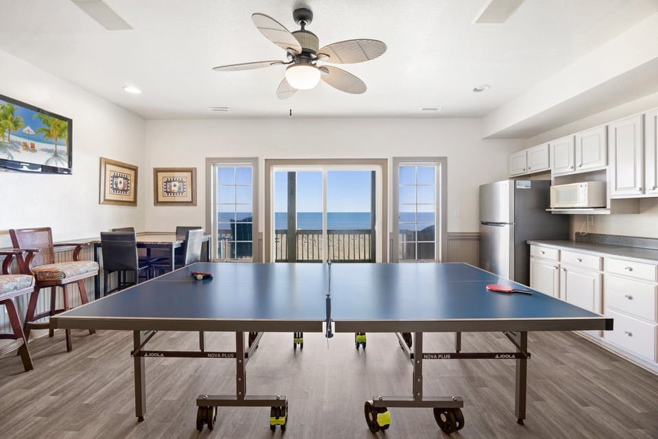 The game room features a wet bar and Ping-Pong table, providing endless entertainment for family and friends.