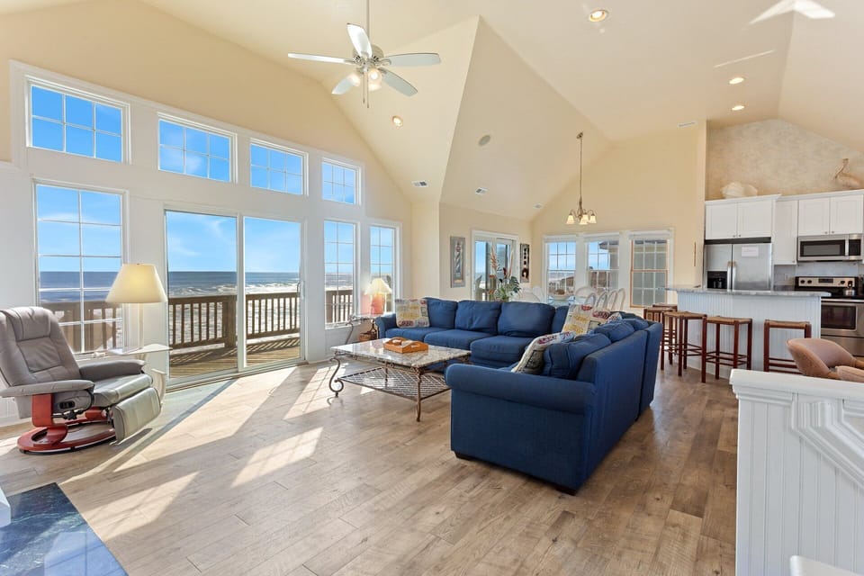 Relax in the spacious Living Area with cathedral ceilings and a flat-screen TV that is perfect for family movie night or catching up on your favorite shows after a day at the beach.