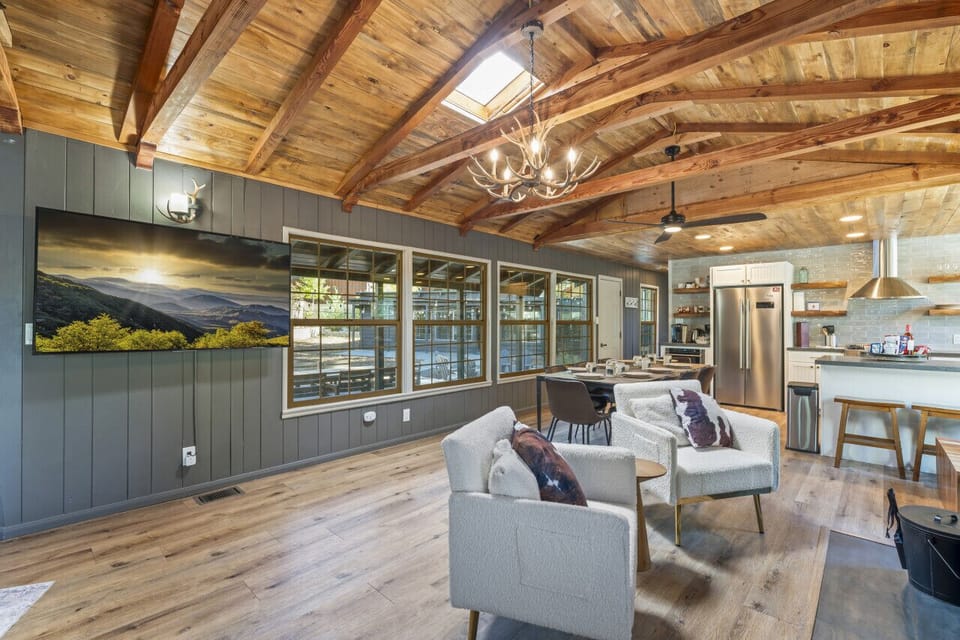 Bright living area w/ vaulted wood ceilings, cozy seating & open flow to the kitchen.
