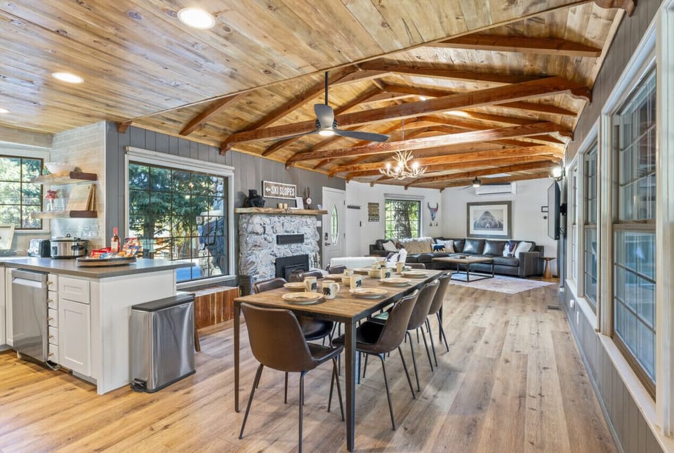 Open-concept kitchen & dining area w/ large island, wood beams & plenty of space to gather.