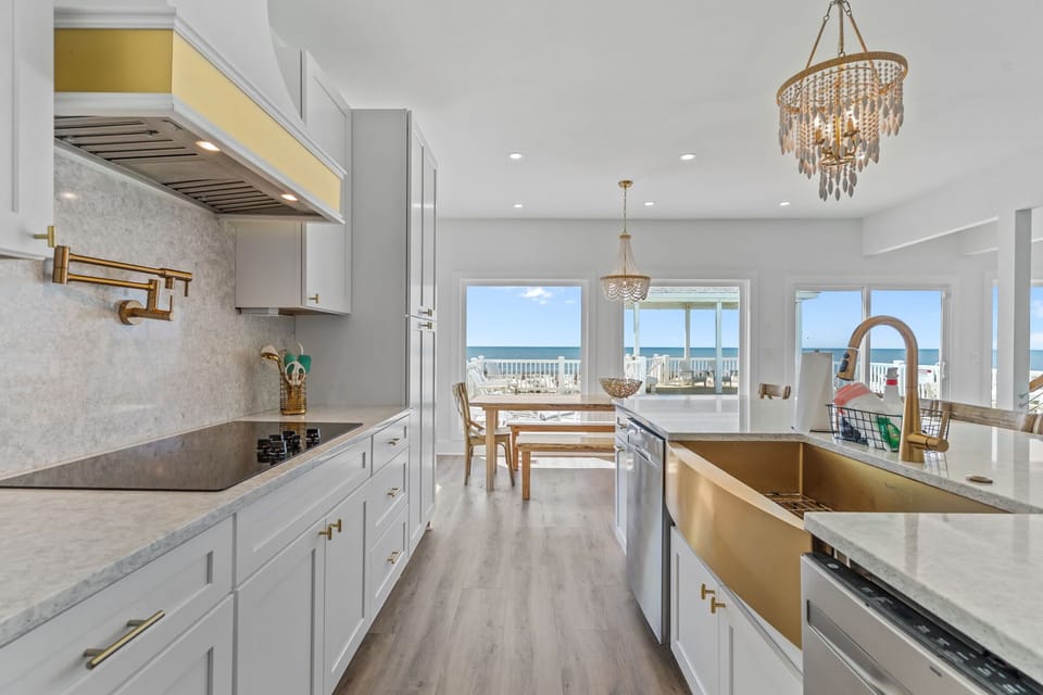 Fully equipped gourmet kitchen with breathtaking ocean views. Features include a refrigerator, dishwasher, stove/oven, microwave, blender, drip coffee maker and much more
