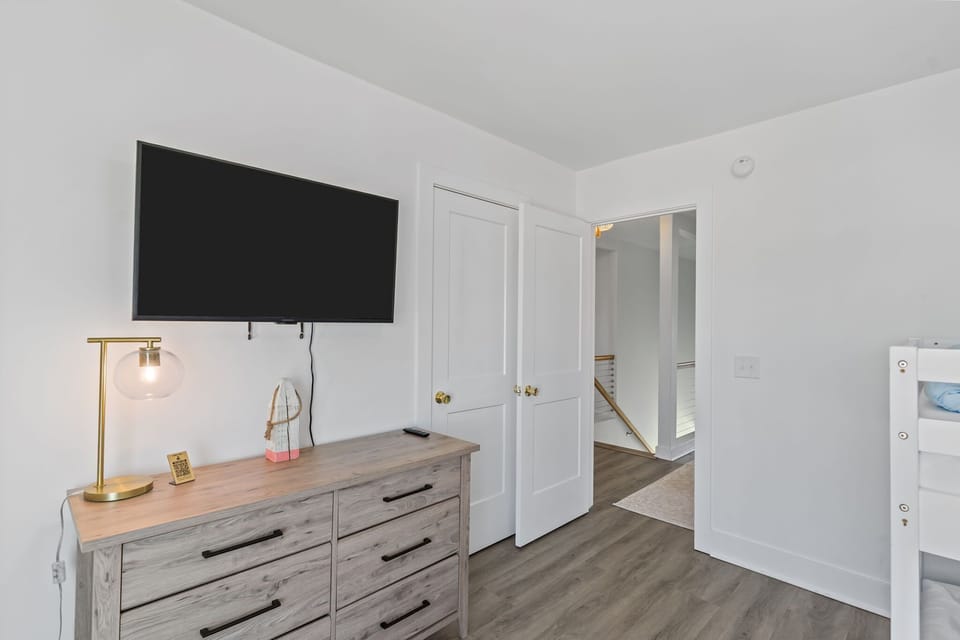 Top level: Double Bunk Bed & Twin Bunk Bed with a flat-screen TV, a built-in slide that kids will love and a large, bright window to keep this playful bunk room feeling light and airy.