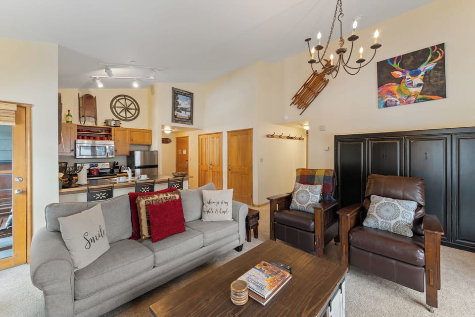 Sink into your cozy living space where rustic charm meets modern comfort, complete with a full kitchen for all your culinary adventures.