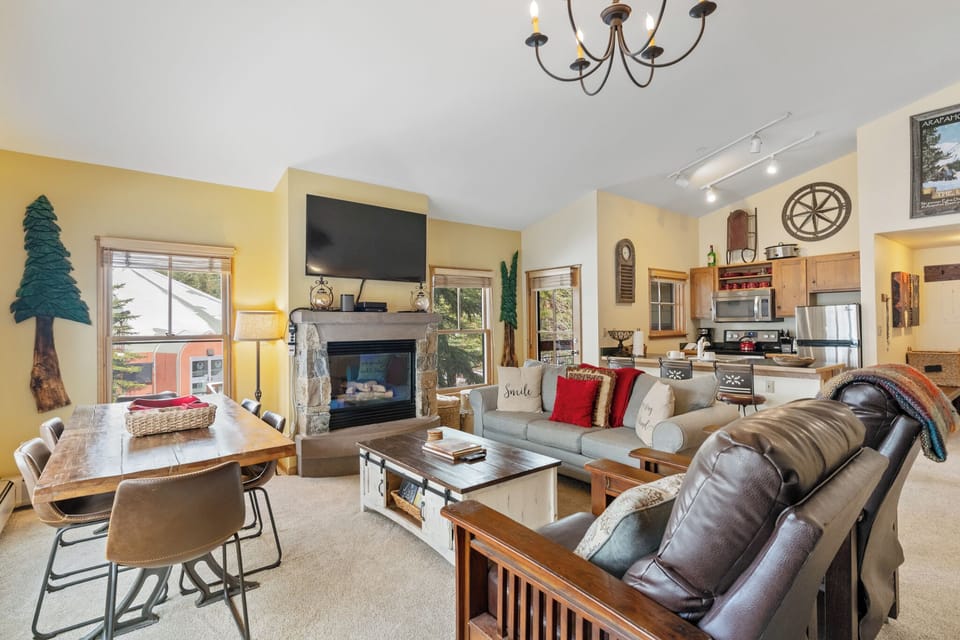 Cozy up by your stone fireplace in this warm living space, where comfort meets mountain charm perfectly.