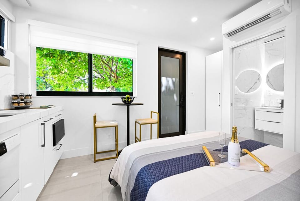 "Bright, modern space with cozy touches and a view of lush greenery."