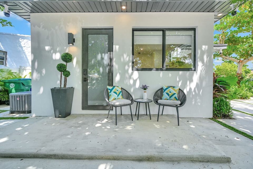 "Cozy patio vibes with modern seating and lush green surroundings."