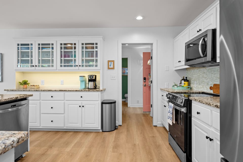 Your bright kitchen features granite counters, glass-front cabinets, and modern appliances for effortless cooking.