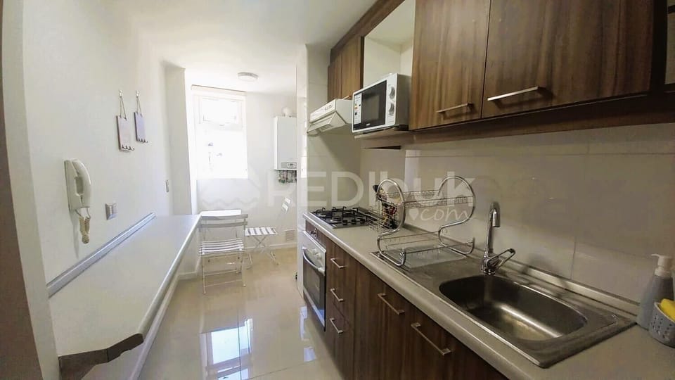 Comfort Apartment | Private kitchen | Stovetop, electric kettle, cookware/dishes/utensils, dining tables