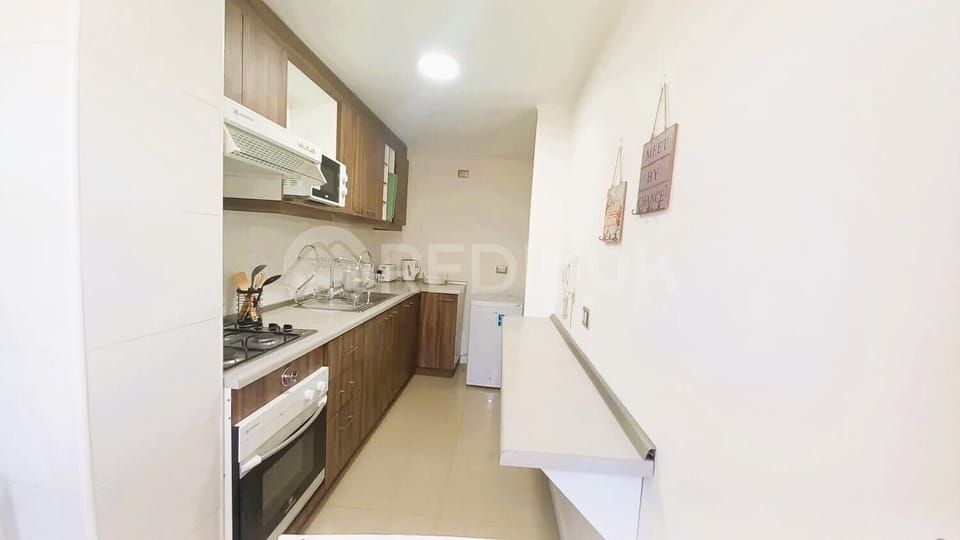 Comfort Apartment | Private kitchen | Stovetop, electric kettle, cookware/dishes/utensils, dining tables