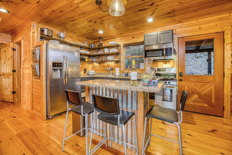 Updated kitchen with brand new stove/oven (not shown) and island w/ new seating