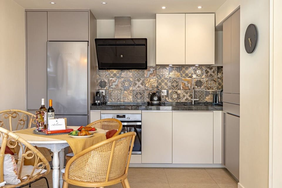 Dining table for four beside the open kitchen