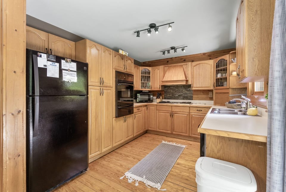 kitchen with full size fridge, oven, gas cooktop, microwave and dishwasher.  tons of cabinet space