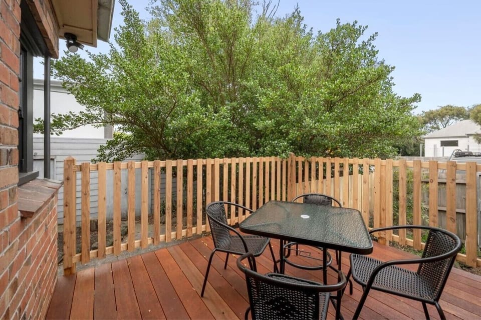Private outdoor deck with seating, perfect for relaxing or entertaining.