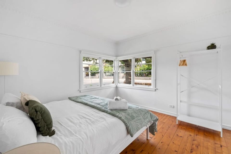 Spacious bedroom with comfortable bedding and plenty of natural light.