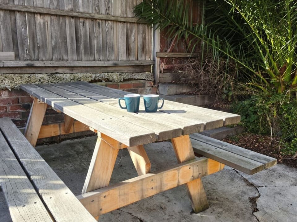 Private outdoor courtyard with seating, perfect for enjoying the fresh coastal air.