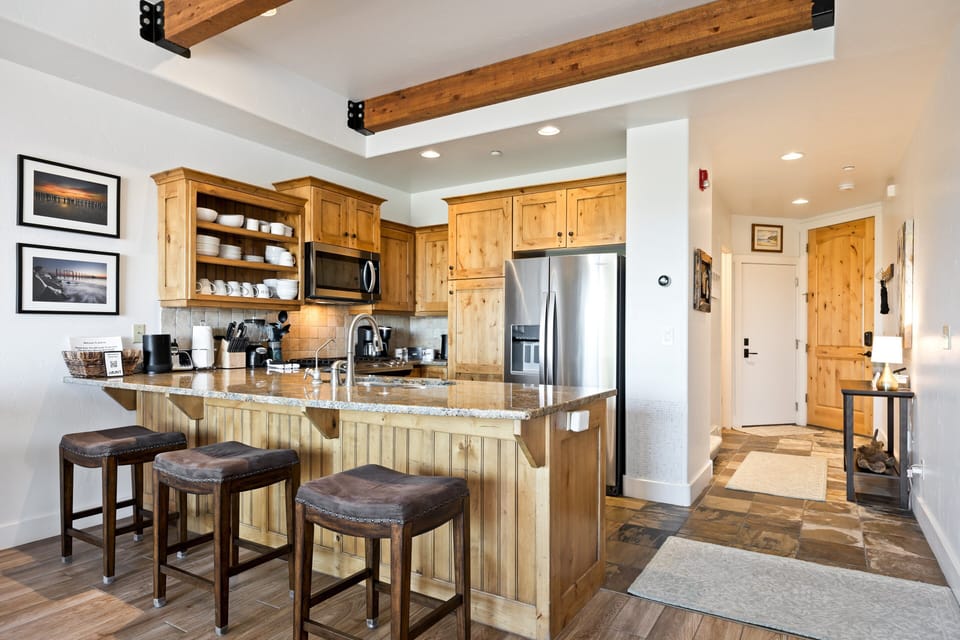 - Modern kitchen with granite countertops  
- Stainless steel appliances fully stocked  
- Open design connects to living and dining