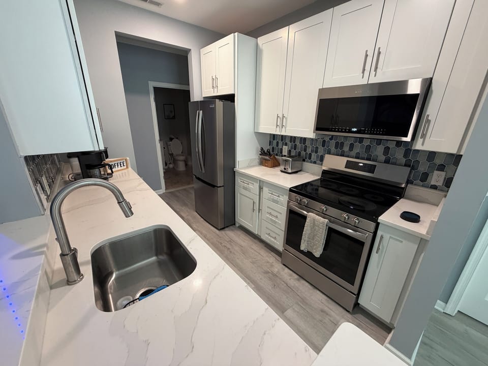 Quartz counters, stainless appliances, and a convenient coffee station