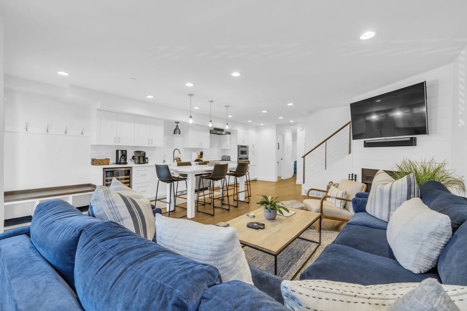 Main Living Space: Open layout, living room, kitchen, dining, chic design, wood-burning fireplace, 65” Smart TV
