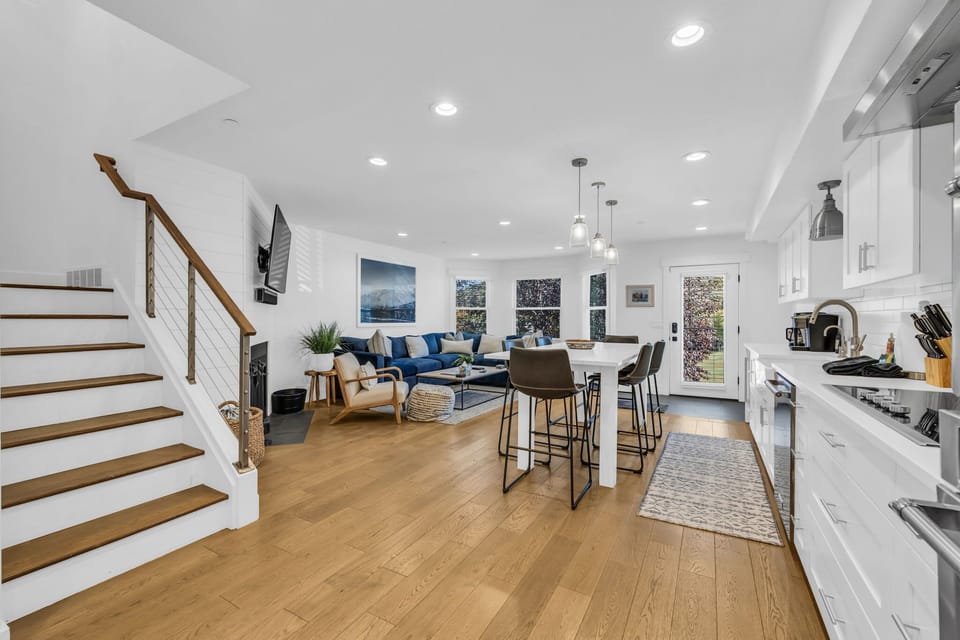 Main Living Space: Open layout, living room, kitchen, dining, chic design, wood-burning fireplace, 65” Smart TV
