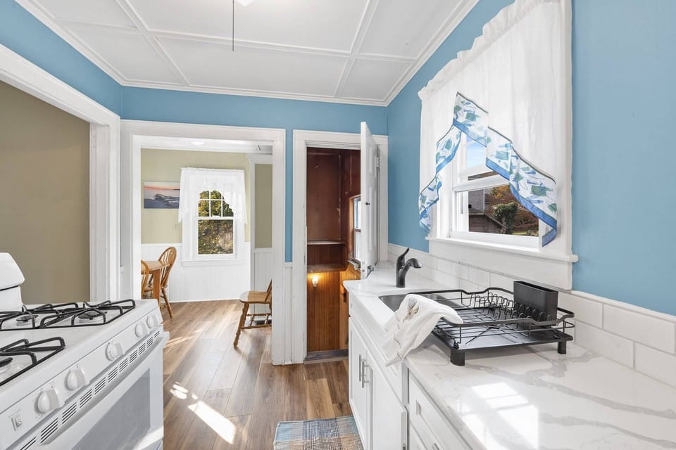 Another view of the kitchen into the breakfast nook and the stairs that bring you down to the 1st floor bedroom suite