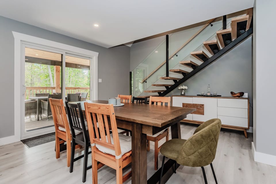 Sliding glass doors open from the dining area to a covered deck, perfect for alfresco dining or enjoying the fresh air no matter the weather.