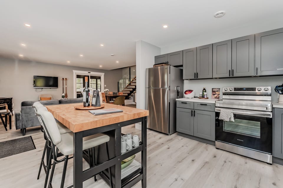 The sleek, modern kitchen is fully equipped with stainless steel appliances, ample counter space, and everything you need to prepare delicious meals during your stay.
