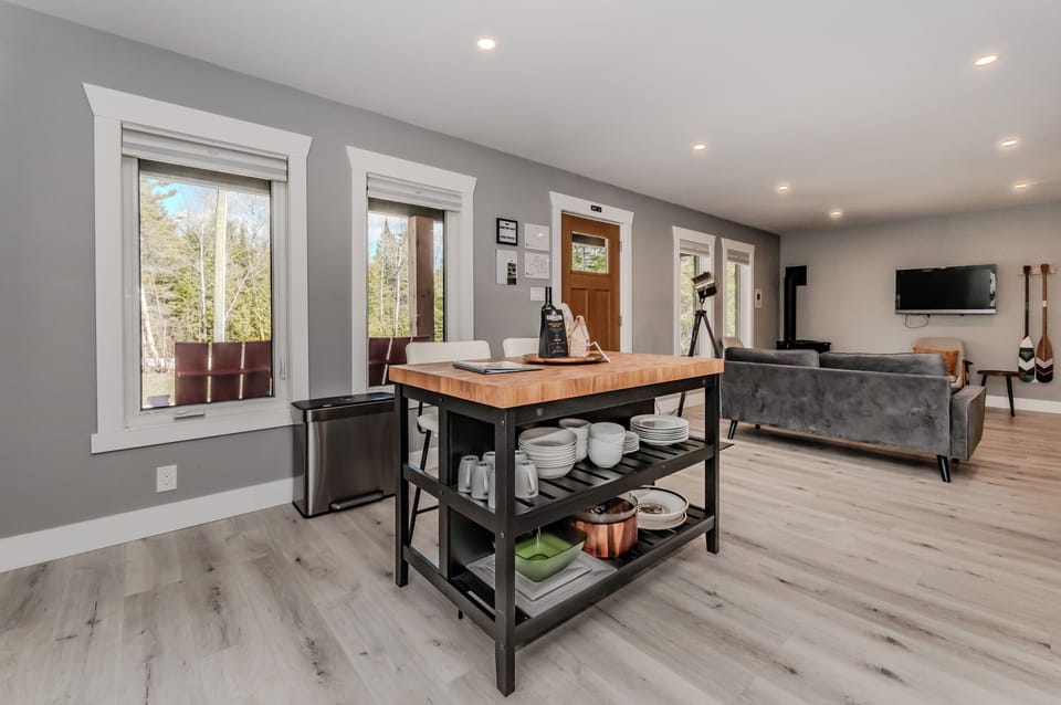 A bright, open-concept kitchen and living space designed for comfort and connection. Enjoy a peaceful retreat where modern convenience meets rustic charm — perfect for relaxing after a day of travel and adventure.