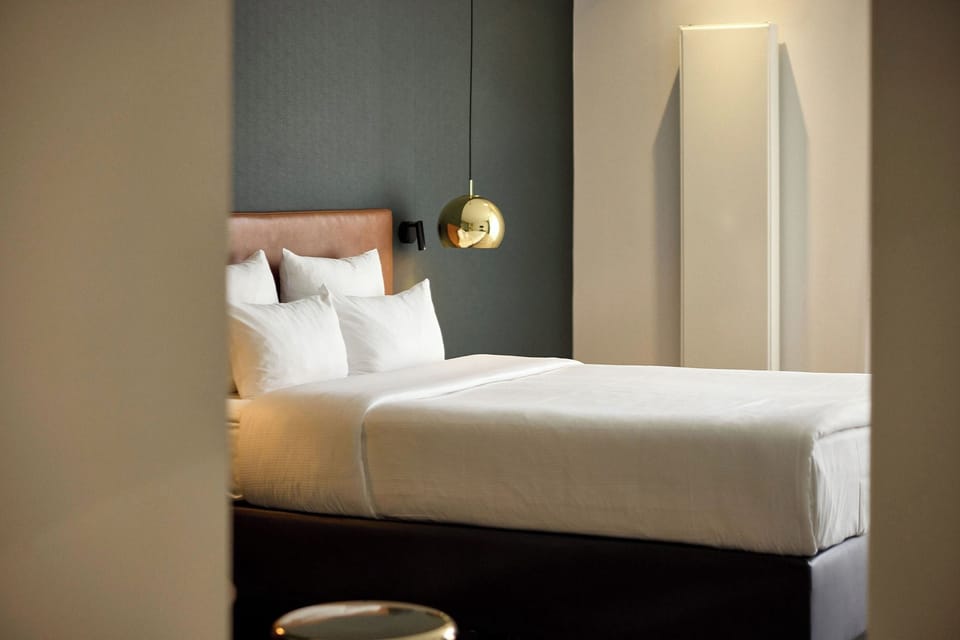 Comfort Room - street side | Minibar, in-room safe, desk, blackout drapes