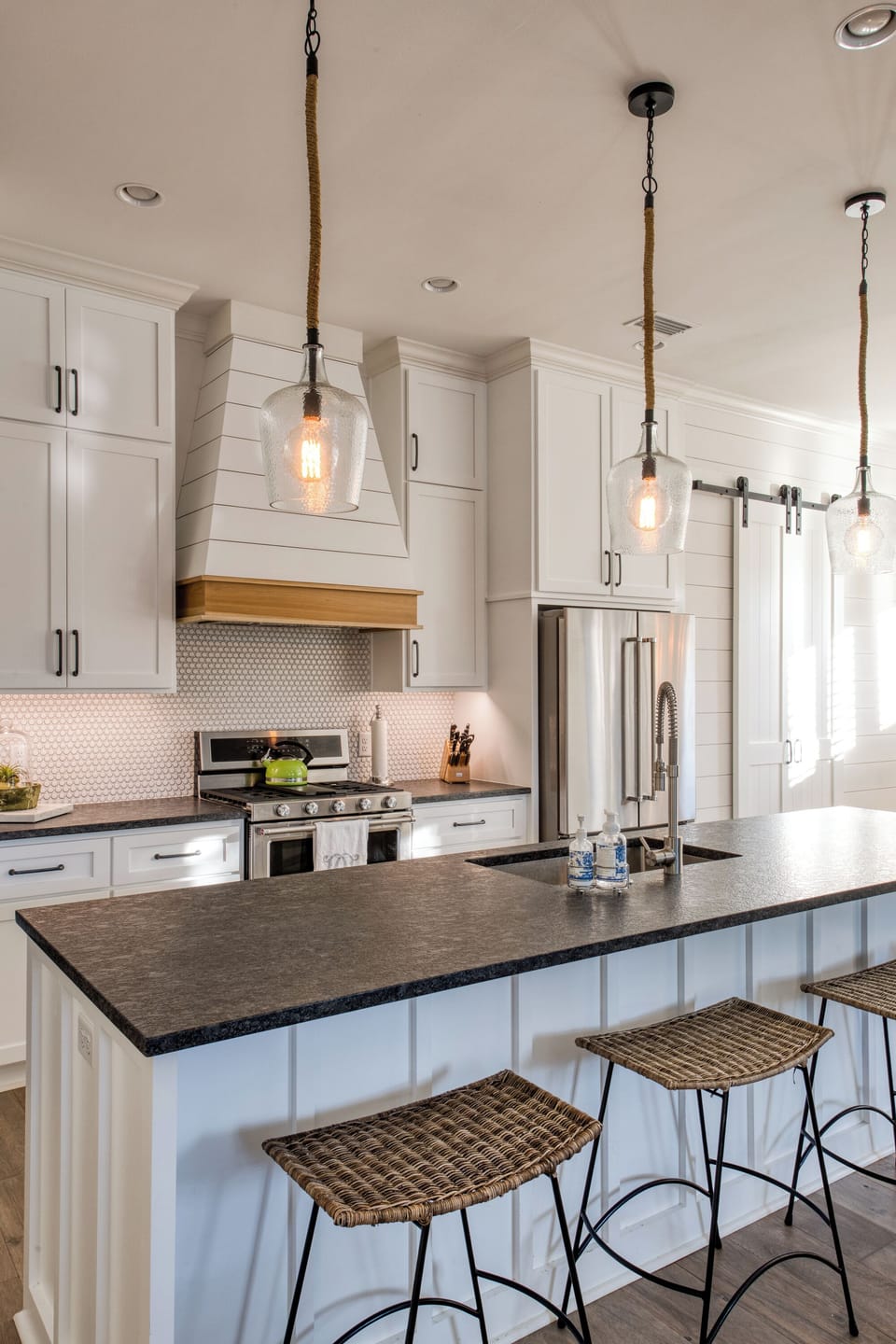 Gas Range, Tile Backsplash, And Fridge - The kitchen has stainless appliances, a gas range, a deep sink, and counter space for cooking between beach runs.