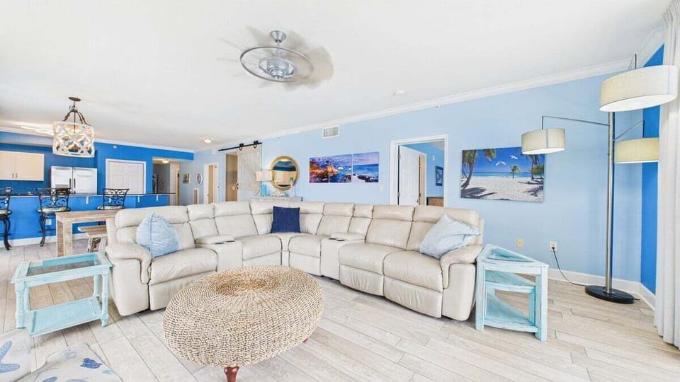 Open concept living area with huge couch and TV