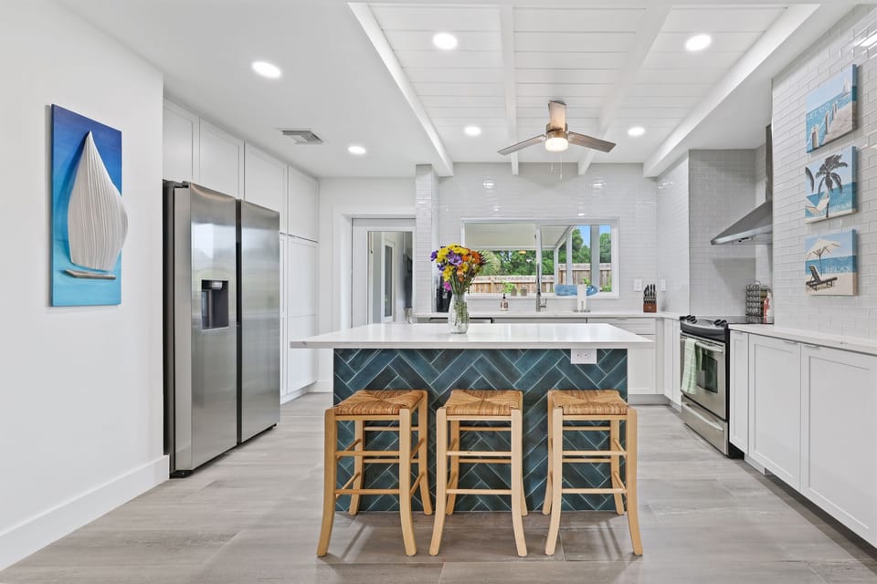 Seamless elegance: Our space combines a fully equipped, high-end kitchen with the stylish comfort of an adjoining living room, perfect for those who appreciate luxury and convenience in Delray Beach.